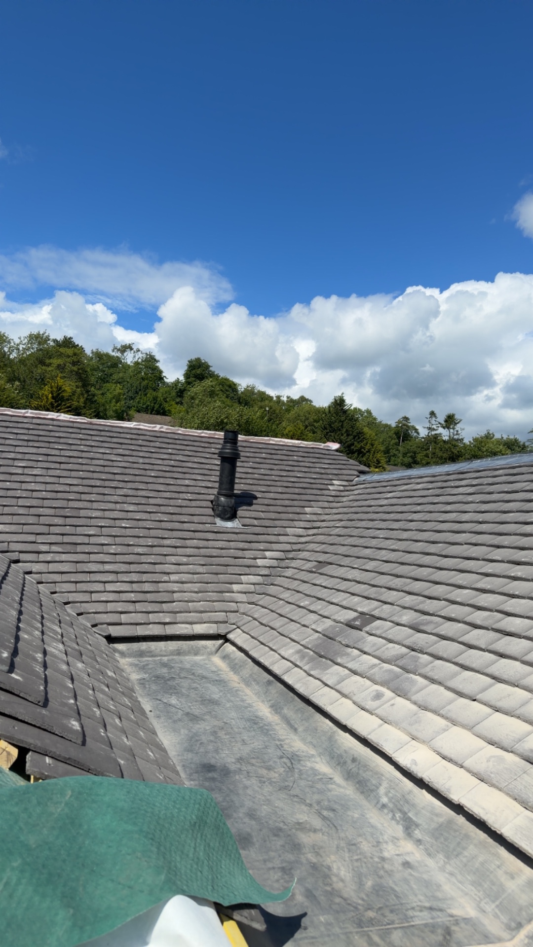 A traditional British brick house with a neatly laid pitched roof