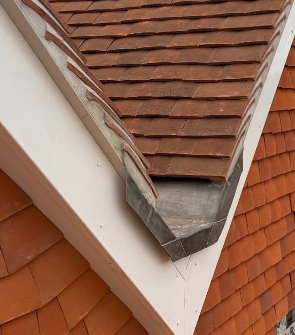 Lead valley and clay plain tiles on a roof repair by Day Roofing