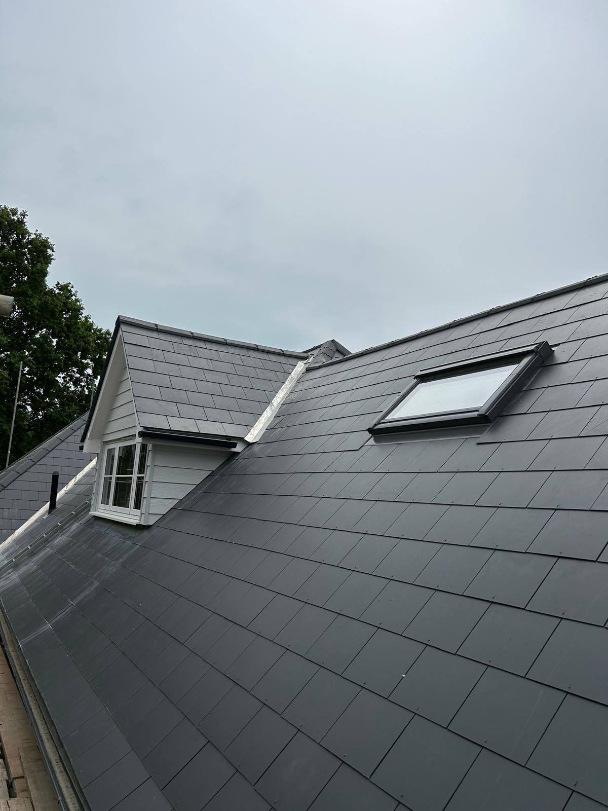 A new natural slate roof with a dormer and roof window, fitted by Day Roofing